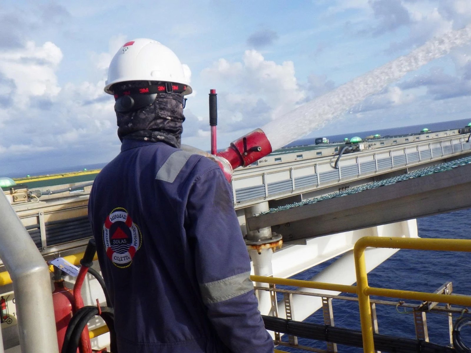 Mermaid technician testing a fire monitor on an offshore helideck