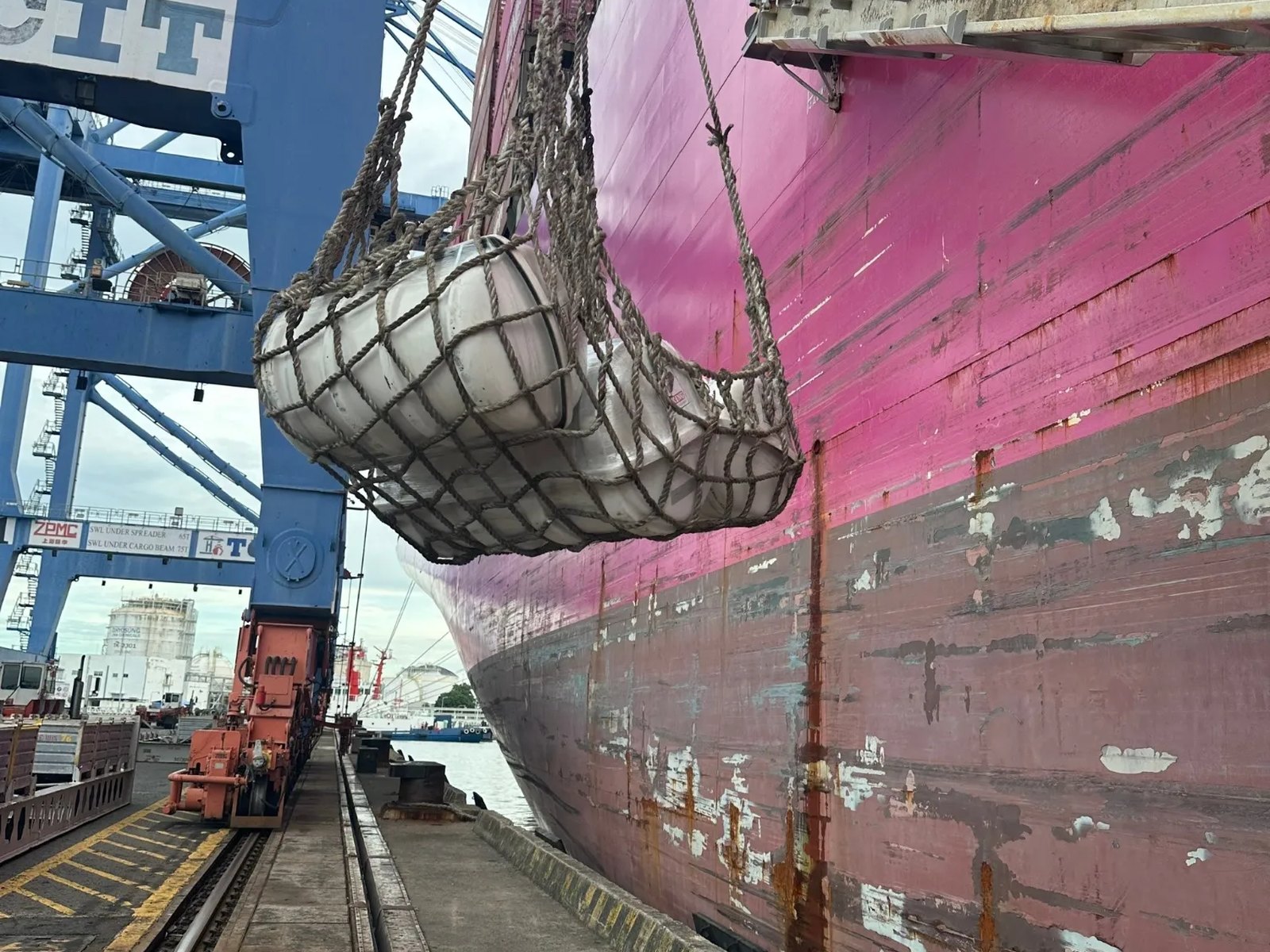 Serviced liferafts lifted aboard a container ship at the quay for exchange